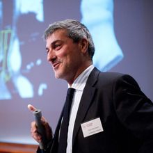 Paolo Macchiarini stands at a podium with a microphone