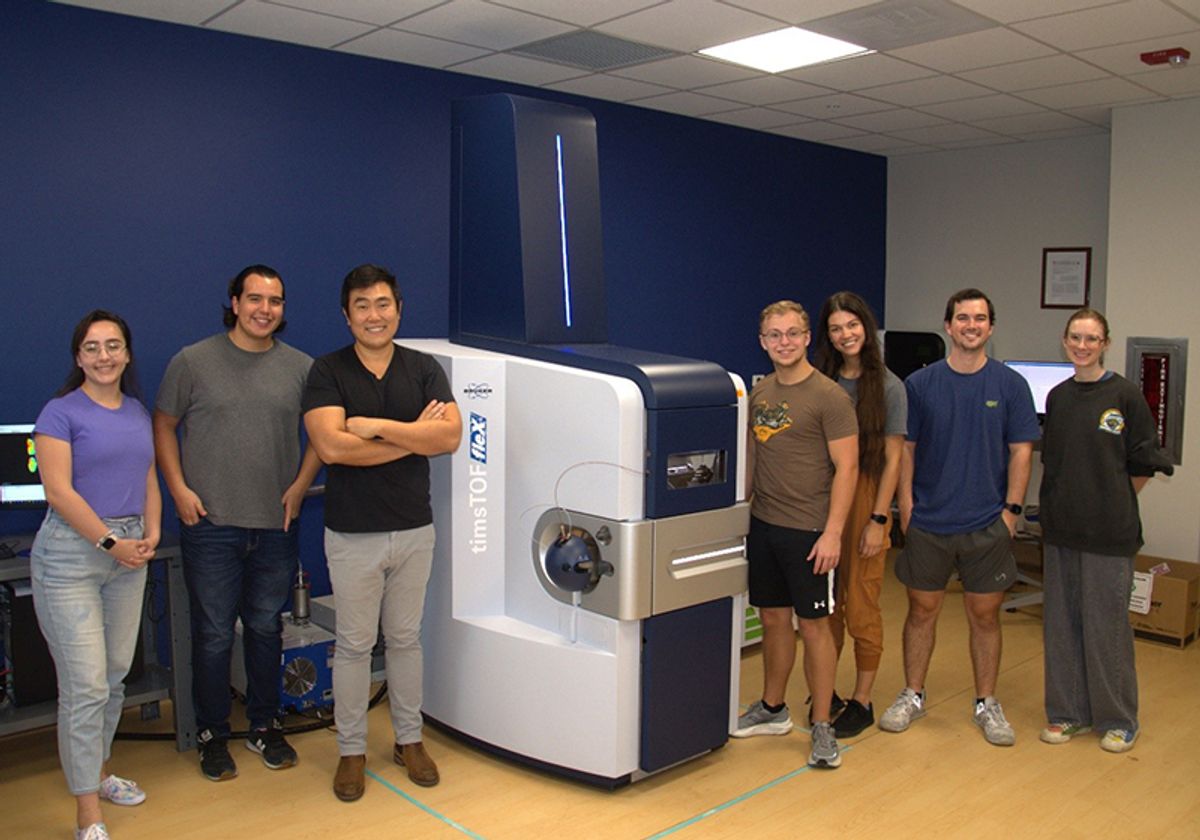 Ramon Sun and his lab standing next to their MALDI imaging mass spectrometer.