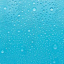Water droplets in front of a blue background.