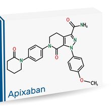 Image of a white cardboard box with a blue vertical stripe on the left side, the word &ldquo;Apixaban&rdquo; in blue lettering at the bottom, and a depiction of apixaban&rsquo;s molecular structure in black.