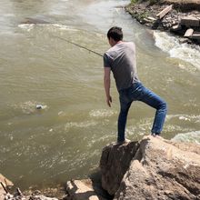 a man collects water using a fishing pole and can