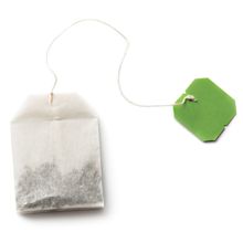 teabag with green tag on a white background